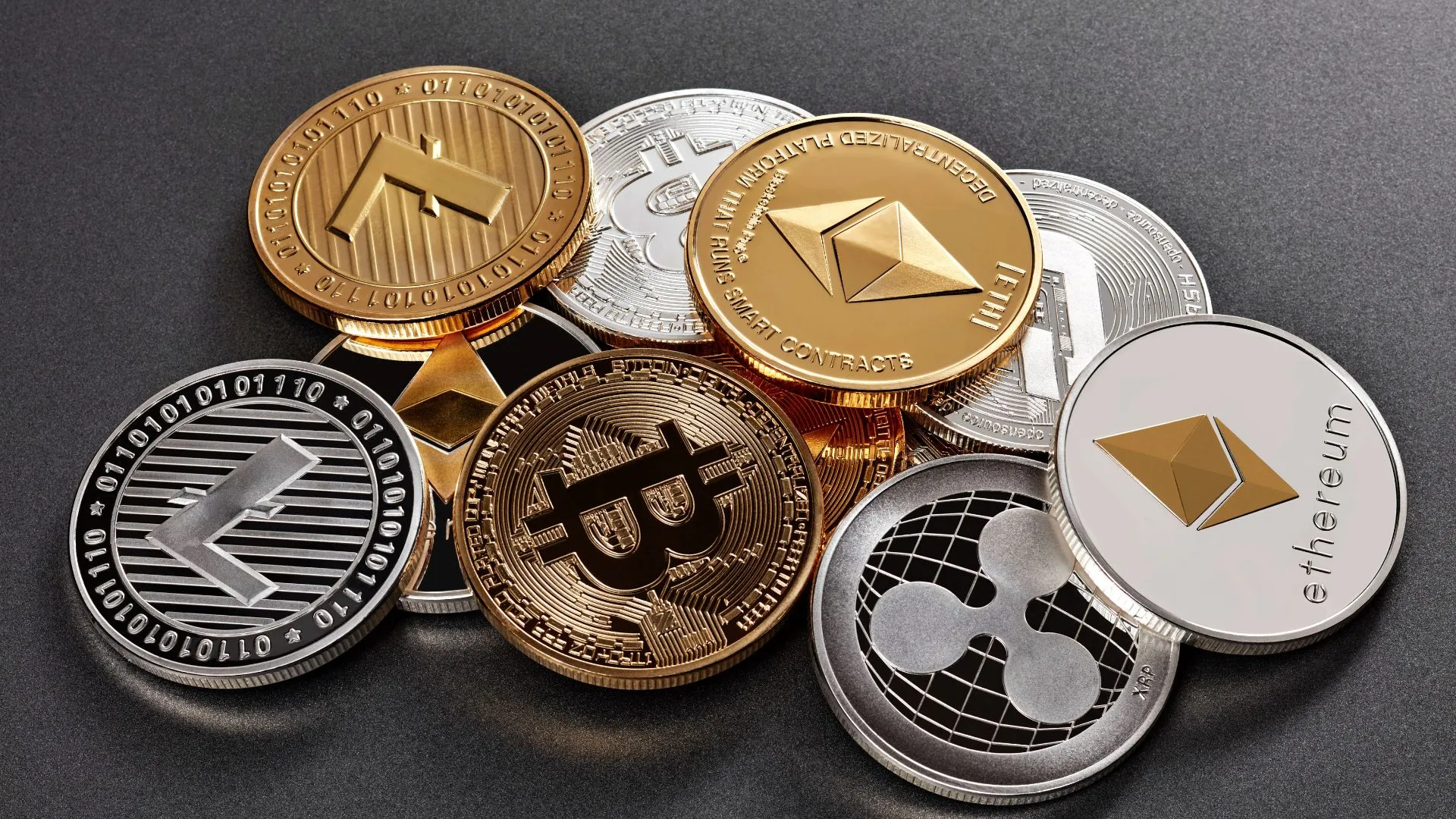 Physical cryptocurrency coins including Bitcoin, Ethereum, XRP, Litecoin and Ripple used in Dubai real estate transactions