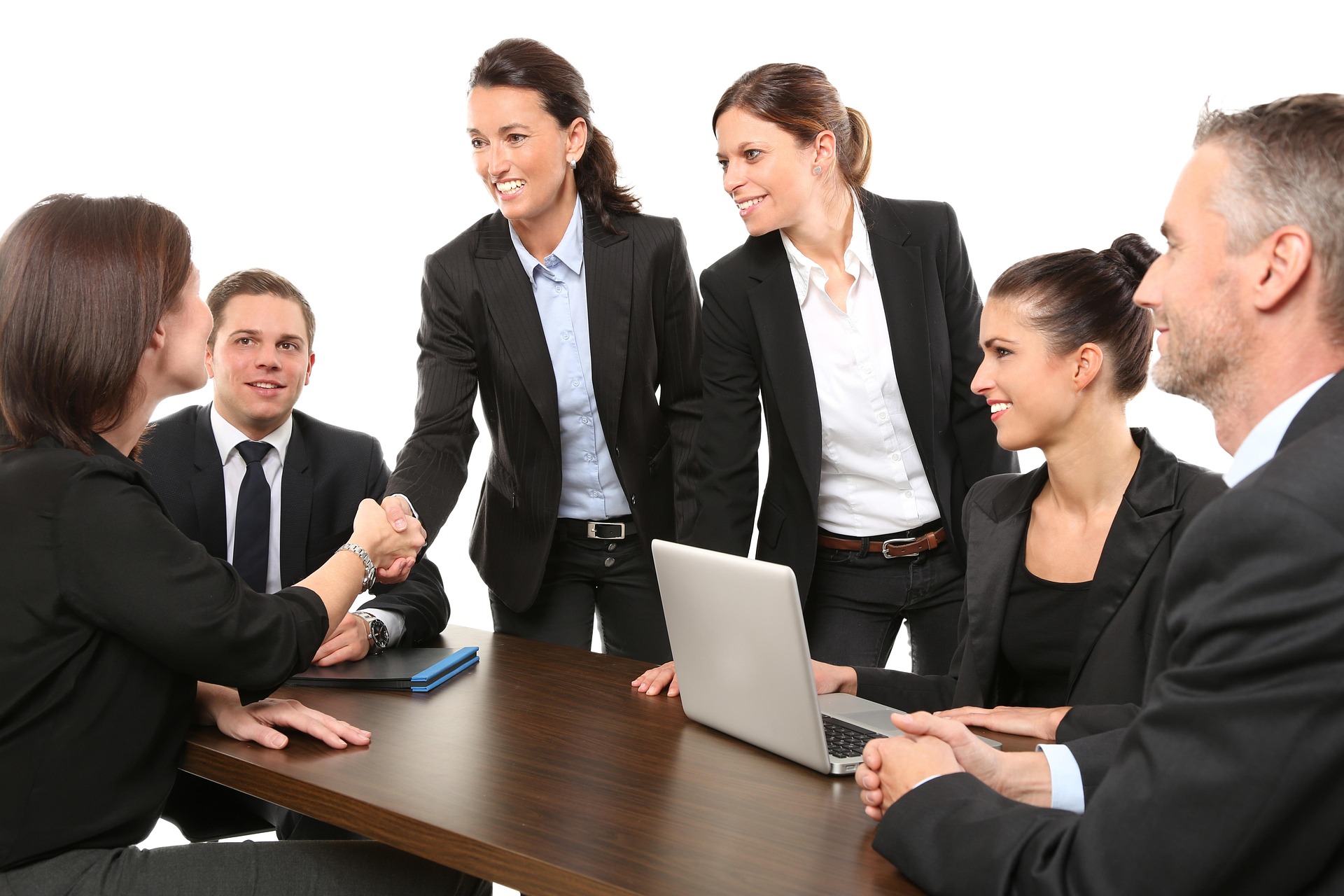 Real estate professionals shaking hands after closing a property deal in Dubai